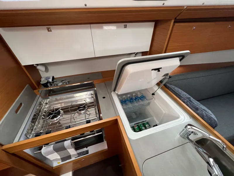 Slide: The Image of Dufour 360 yacht kitchen interior with stove and open fridge, 2021 model. - 26