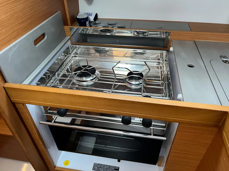Slide: The Image of Modern kitchen stove in 2021 Dufour 360 yacht, featuring dual burners and sleek design. - 28