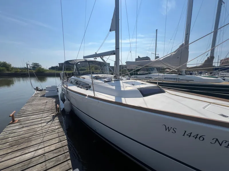 Slide: The Image of 2021 Dufour 360 sailboat docked at marina under clear blue sky. - 3