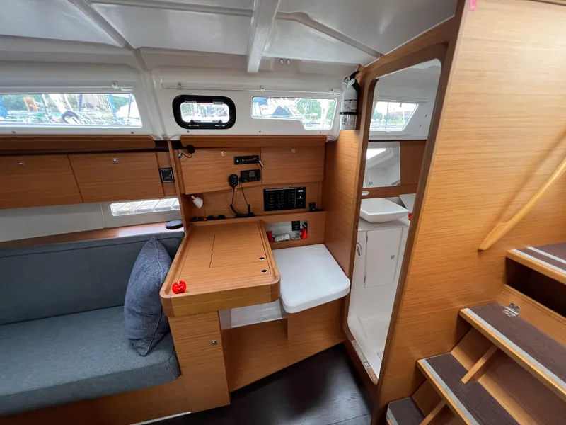 Slide: The Image of Interior of 2021 Dufour 360 sailboat with wooden finish and compact design. - 30