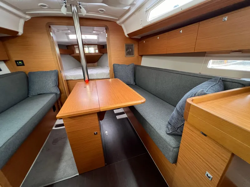 Slide: The Image of Interior of 2021 Dufour 360 yacht with wooden furnishings and cozy seating. - 36