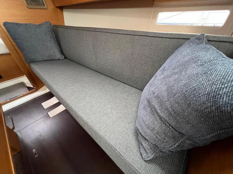 Slide: The Image of Dufour 360 2021 yacht interior with gray cushioned seating and pillows. - 37