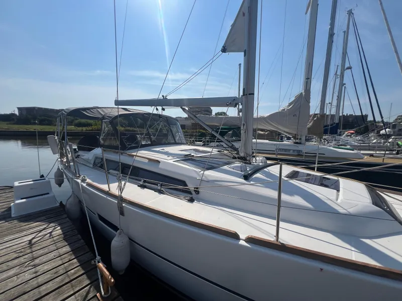Slide: The Image of 2021 Dufour 360 sailboat docked at marina under clear blue sky. - 4
