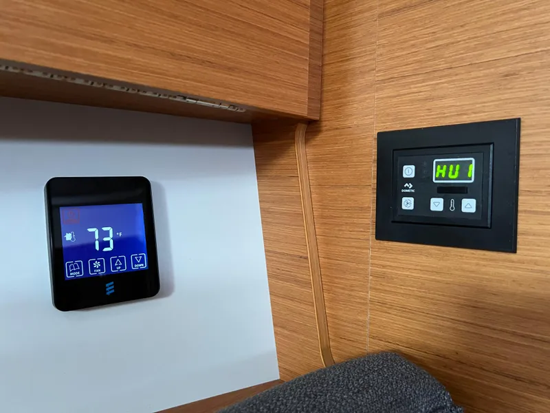 Slide: The Image of Control panels on 2021 Dufour 360 yacht interior, displaying temperature and settings. - 42