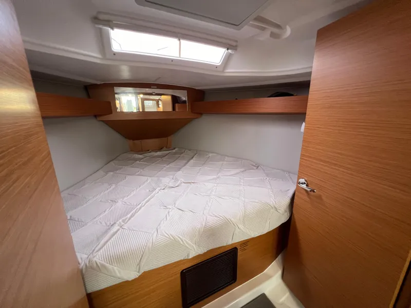 Slide: The Image of 2021 Dufour 360 yacht cabin with cozy bed and wooden interior. - 43