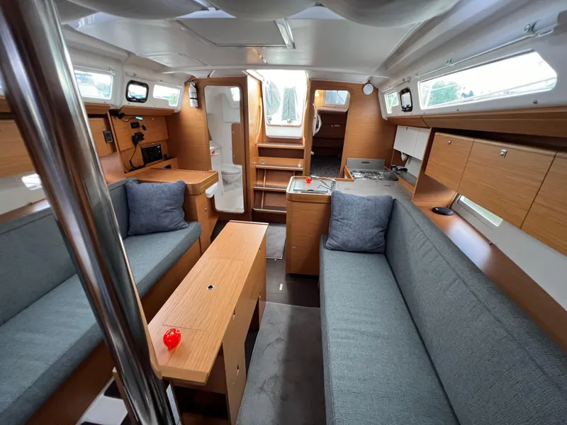 Slide: The Image of Interior of 2021 Dufour 360 sailboat with modern wood finish and cozy seating. - 46