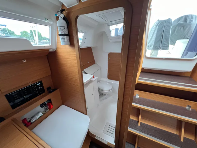 Slide: The Image of Interior of 2021 Dufour 360 yacht, featuring a compact bathroom and wooden cabinetry. - 47