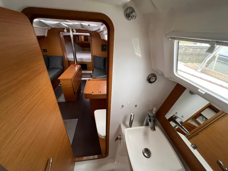 Slide: The Image of Interior of 2021 Dufour 360 yacht, featuring a cozy cabin and modern bathroom. - 49