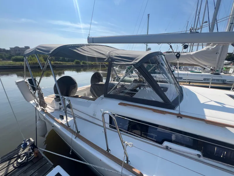 Slide: The Image of 2021 Dufour 360 sailboat docked, featuring a sleek design and spacious cockpit. - 5