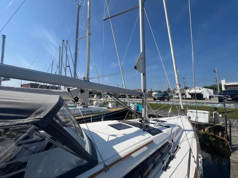 Slide: The Image of 2021 Dufour 360 sailboat docked at marina under clear blue sky. - 6