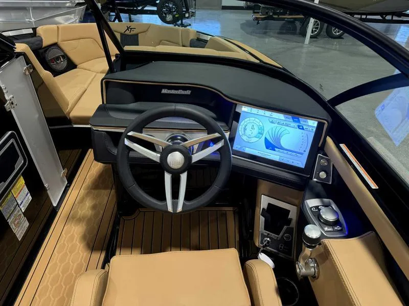 Slide: The Image of 2025 MasterCraft XT23 boat interior with modern dashboard and touchscreen display. - 10