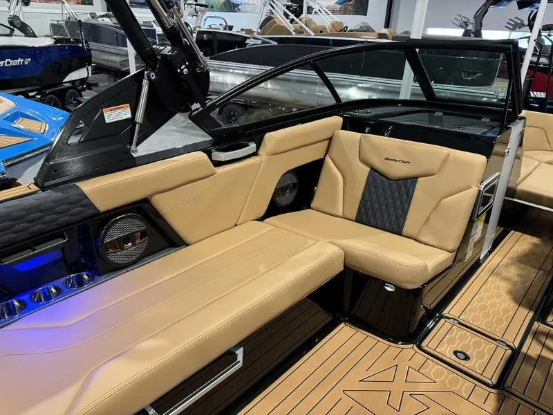Slide: The Image of 2025 MasterCraft XT23 boat interior with tan leather seating and modern design. - 8