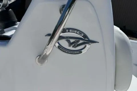 Slide: The Image of 2025 Tidewater 180 CC Adventure logo on white boat surface. - 7