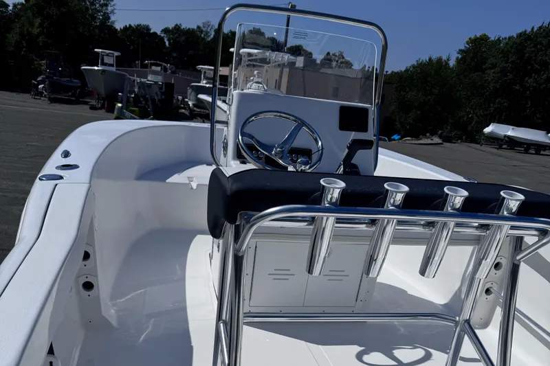 Slide: The Image of 2025 Tidewater 180 CC Adventure boat interior with steering console and rod holders. - 9