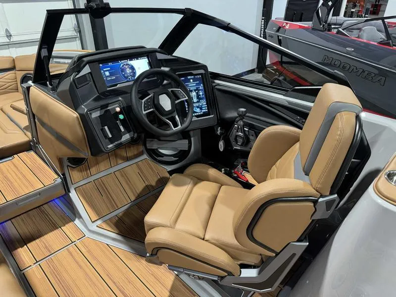 Slide: The Image of 2025 Supra SE boat interior with modern dashboard and tan leather seating. - 12