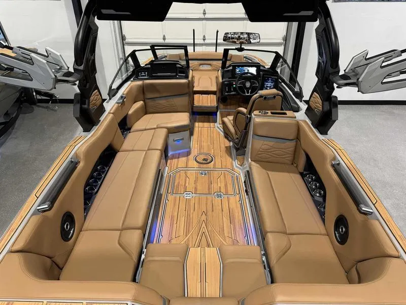 Slide: The Image of Luxurious 2025 Supra SE boat interior with tan leather seating and advanced dashboard features. - 13