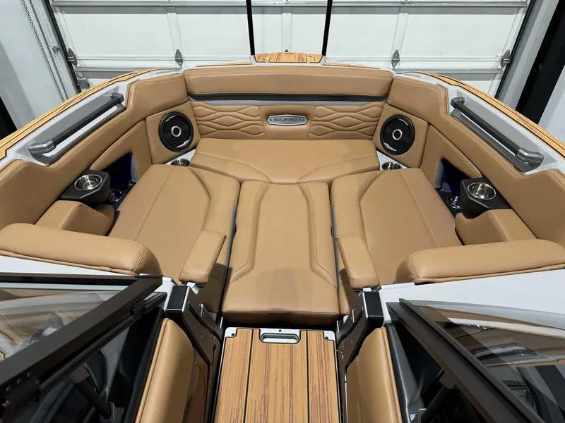 Slide: The Image of 2025 Supra SE boat interior with tan leather seating and built-in speakers. - 14