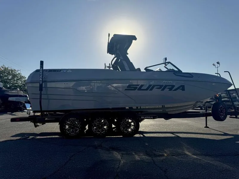 Slide: The Image of 2025 Supra SE boat on trailer, silhouetted against the sun, showcasing sleek design. - 3