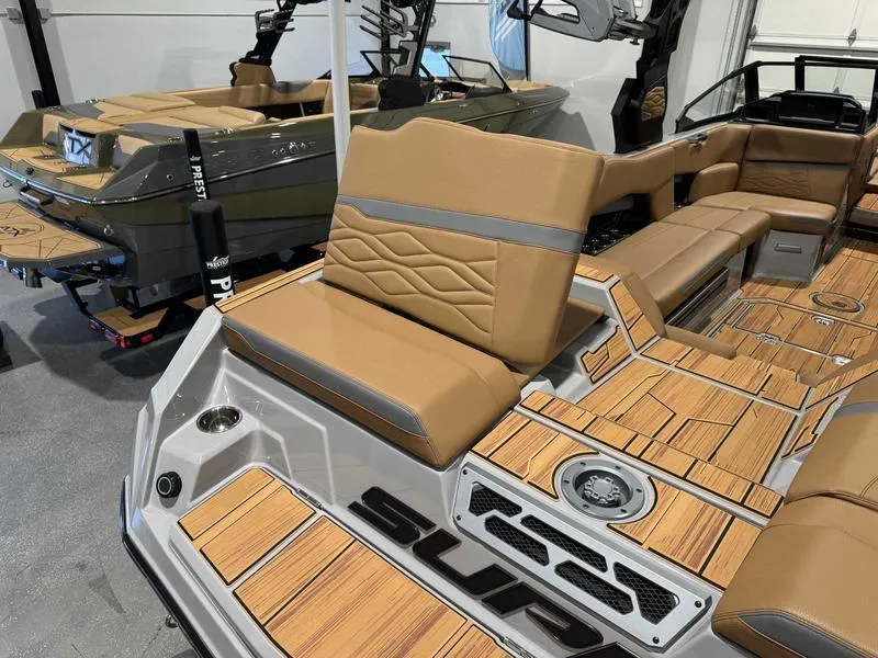 Slide: The Image of 2025 Supra SE boat interior with tan leather seats and wood accents. - 6