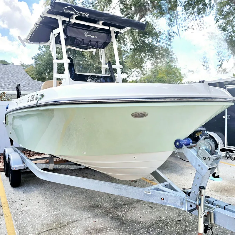 Slide: The Image of 2022 Bayliner Trophy T20CC boat on trailer, parked outdoors. - 0