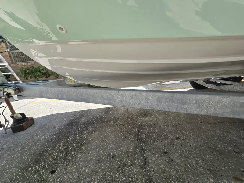 Slide: The Image of 2022 Bayliner Trophy T20CC boat hull on a trailer, close-up view. - 14