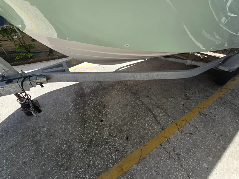 Slide: The Image of 2022 Bayliner Trophy T20CC boat on trailer, parked on concrete surface. - 17