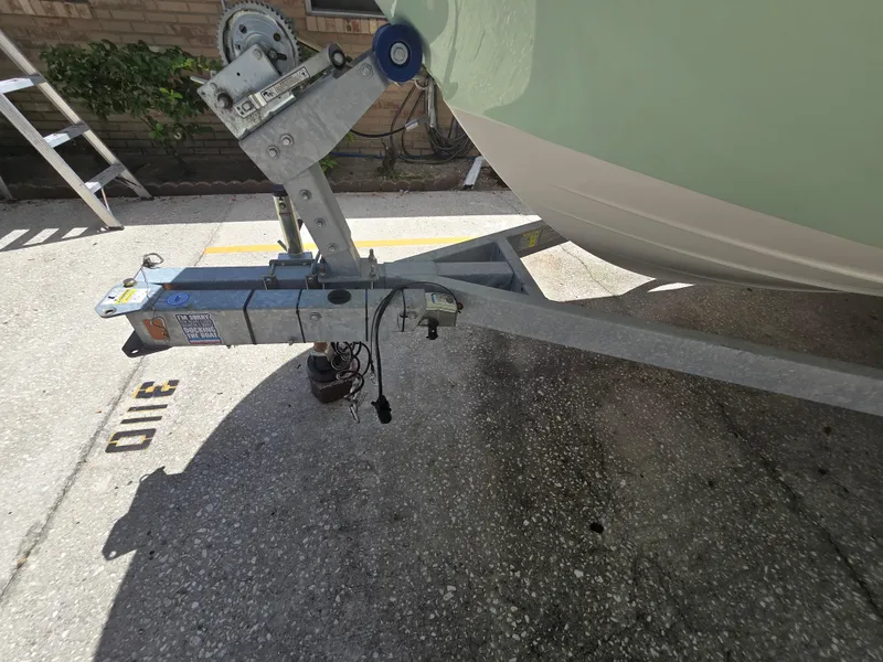 Slide: The Image of 2022 Bayliner Trophy T20CC boat trailer hitch in a parking area. - 19