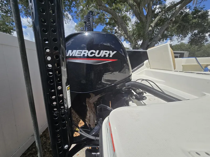 Slide: The Image of 2022 Bayliner Trophy T20CC with Mercury outboard motor, parked outdoors. - 23