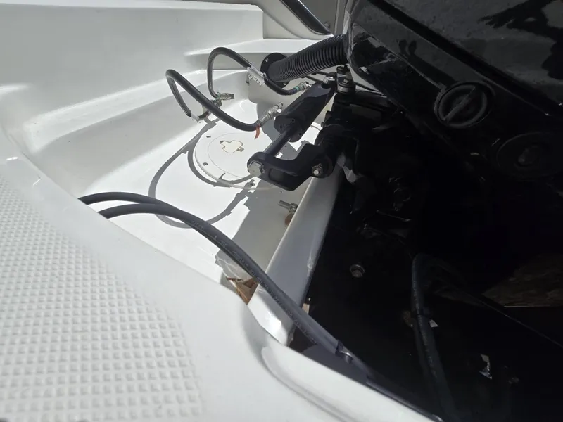 Slide: The Image of 2022 Bayliner Trophy T20CC boat engine compartment with cables and components. - 24