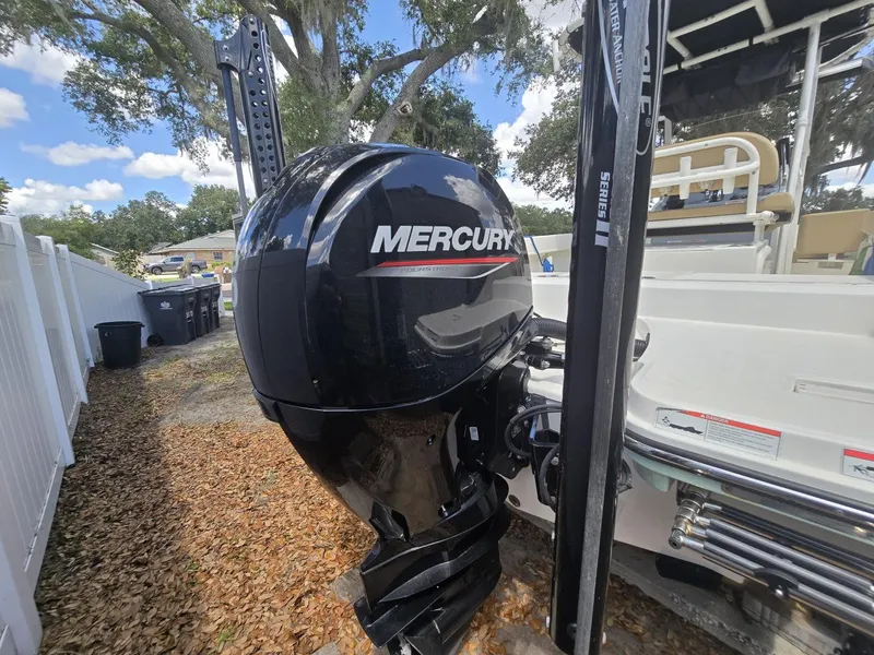 Slide: The Image of 2022 Bayliner Trophy T20CC with Mercury outboard motor, parked outdoors. - 26