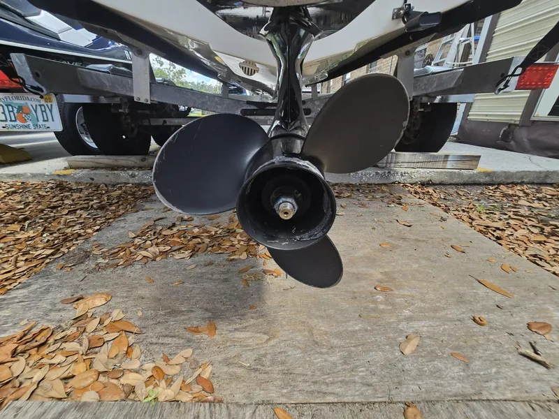 Slide: The Image of 2022 Bayliner Trophy T20CC boat propeller on trailer, surrounded by fallen leaves. - 29