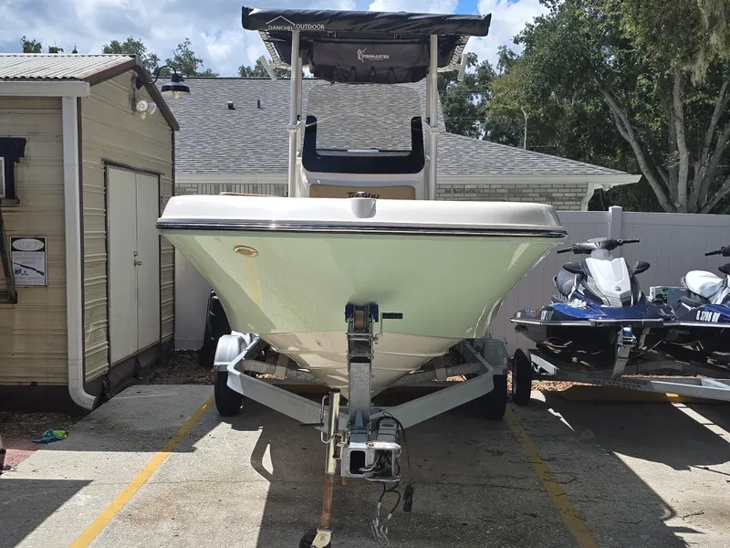 Slide: The Image of 2022 Bayliner Trophy T20CC boat on trailer, parked beside jet skis. - 3