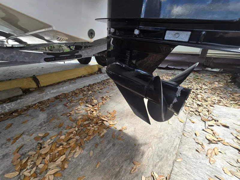 Slide: The Image of 2022 Bayliner Trophy T20CC boat propeller on a trailer, surrounded by fallen leaves. - 31