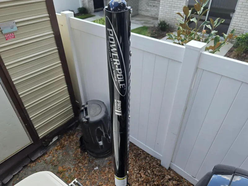 Slide: The Image of Power-Pole anchor on 2022 Bayliner Trophy T20CC boat, near white fence. - 33