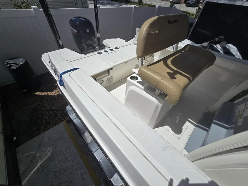 Slide: The Image of 2022 Bayliner Trophy T20CC boat interior with seating and motor. - 34