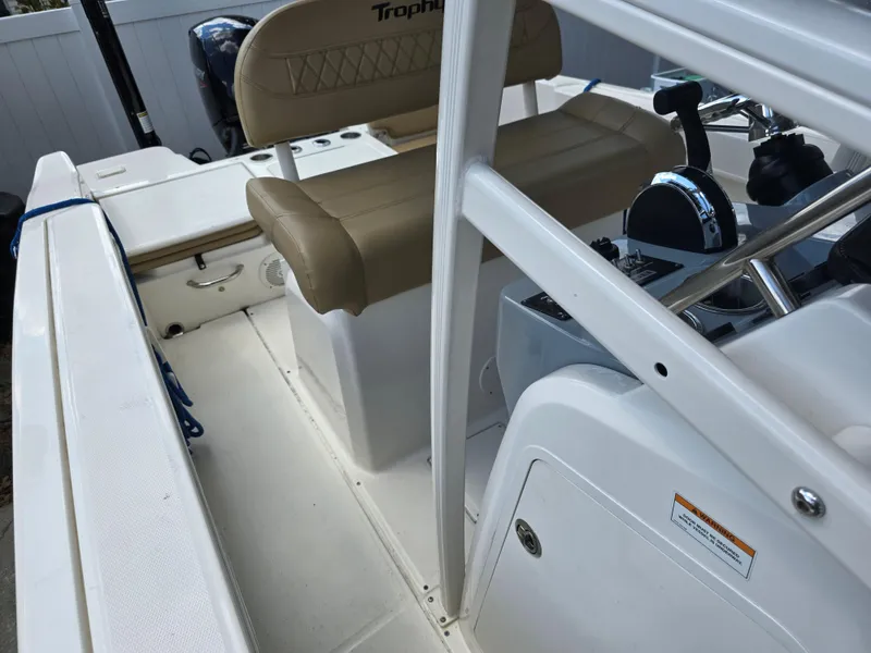Slide: The Image of 2022 Bayliner Trophy T20CC boat interior with beige seating and control panel. - 35