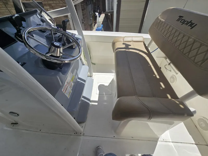 Slide: The Image of 2022 Bayliner Trophy T20CC boat interior with steering wheel and seating. - 37