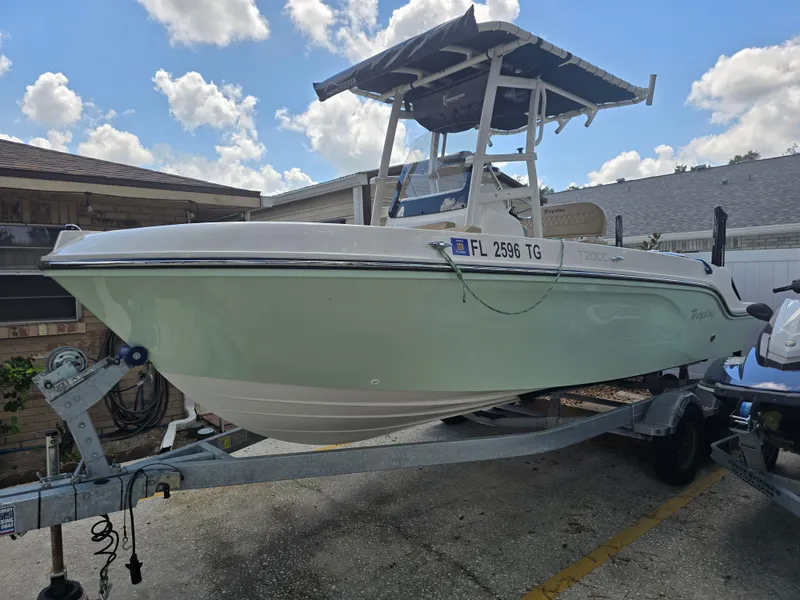 Slide: The Image of 2022 Bayliner Trophy T20CC boat on trailer under blue sky. - 4