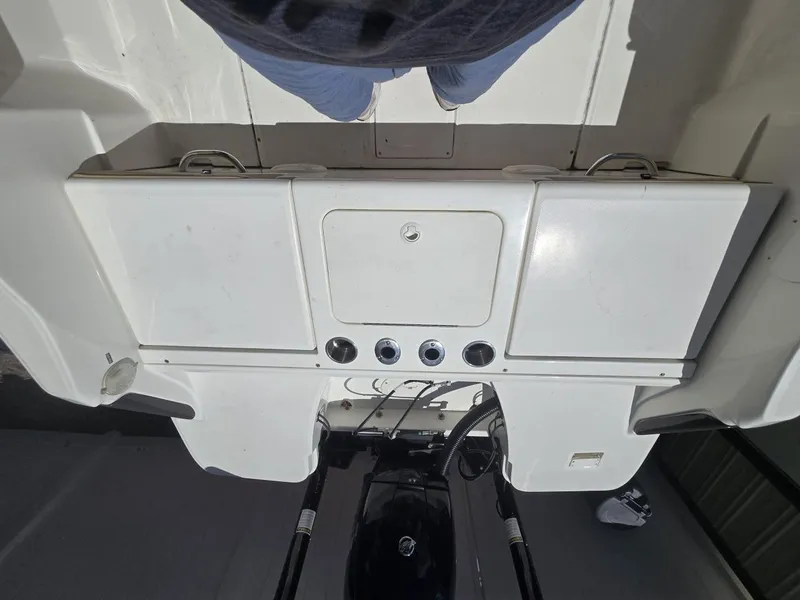 Slide: The Image of 2022 Bayliner Trophy T20CC boat deck with storage compartments and controls. - 44