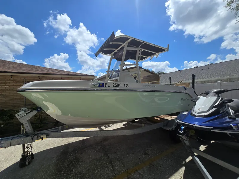 Slide: The Image of 2022 Bayliner Trophy T20CC boat on trailer under blue sky. - 7