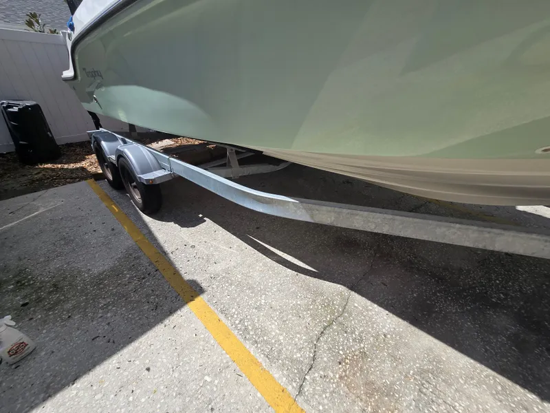 Slide: The Image of 2022 Bayliner Trophy T20CC boat on trailer, parked in a sunny area. - 9
