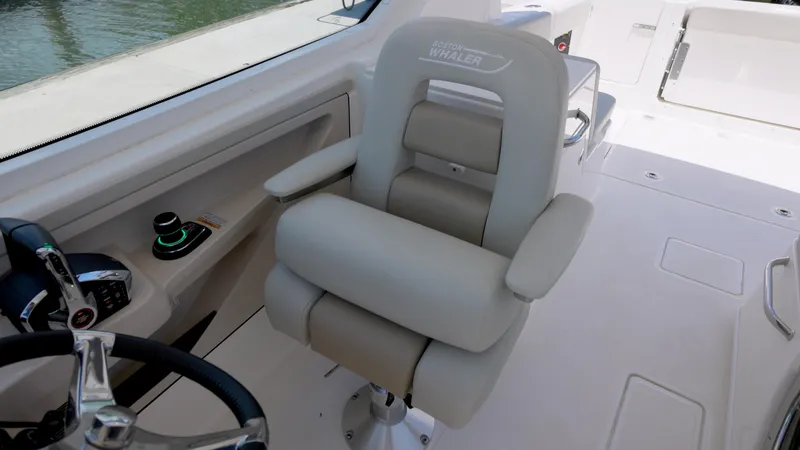 Slide: The Image of Captain's chair on 2024 Boston Whaler 280 Vantage boat, featuring sleek design and controls. - 6