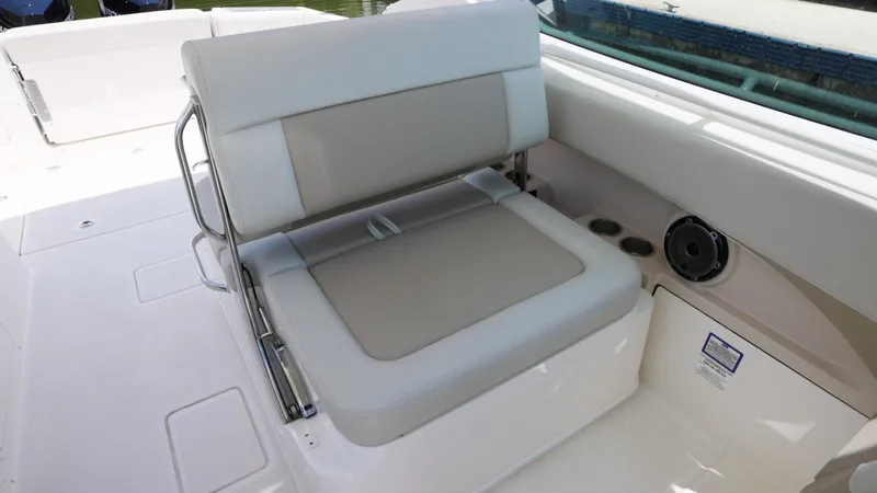 Slide: The Image of 2024 Boston Whaler 280 Vantage boat seat with white and beige upholstery. - 8