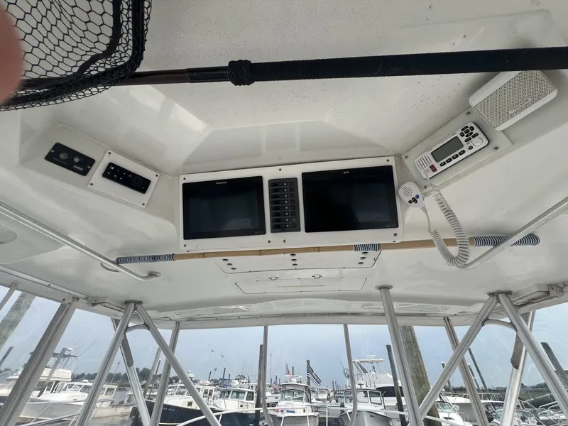 Slide: The Image of 1995 Luhrs 320 Open boat cockpit with navigation equipment and marina view. - 12
