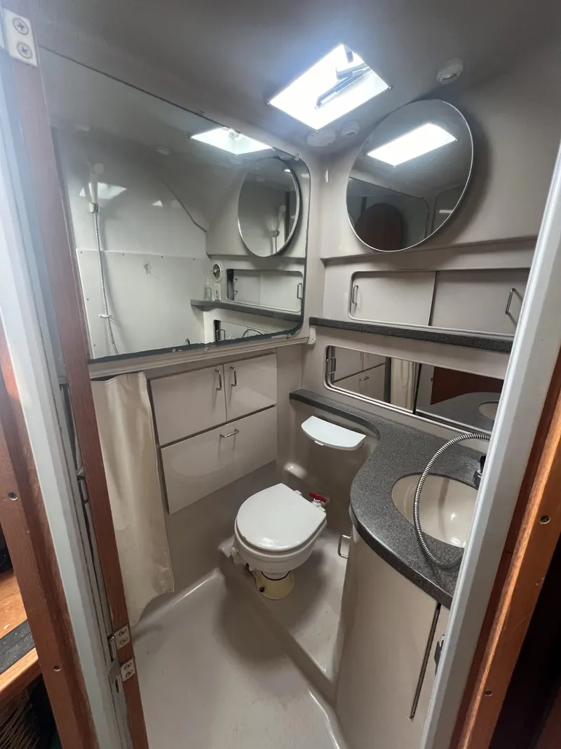 Slide: The Image of 1995 Luhrs 320 Open boat bathroom with modern fixtures and ample storage. - 18