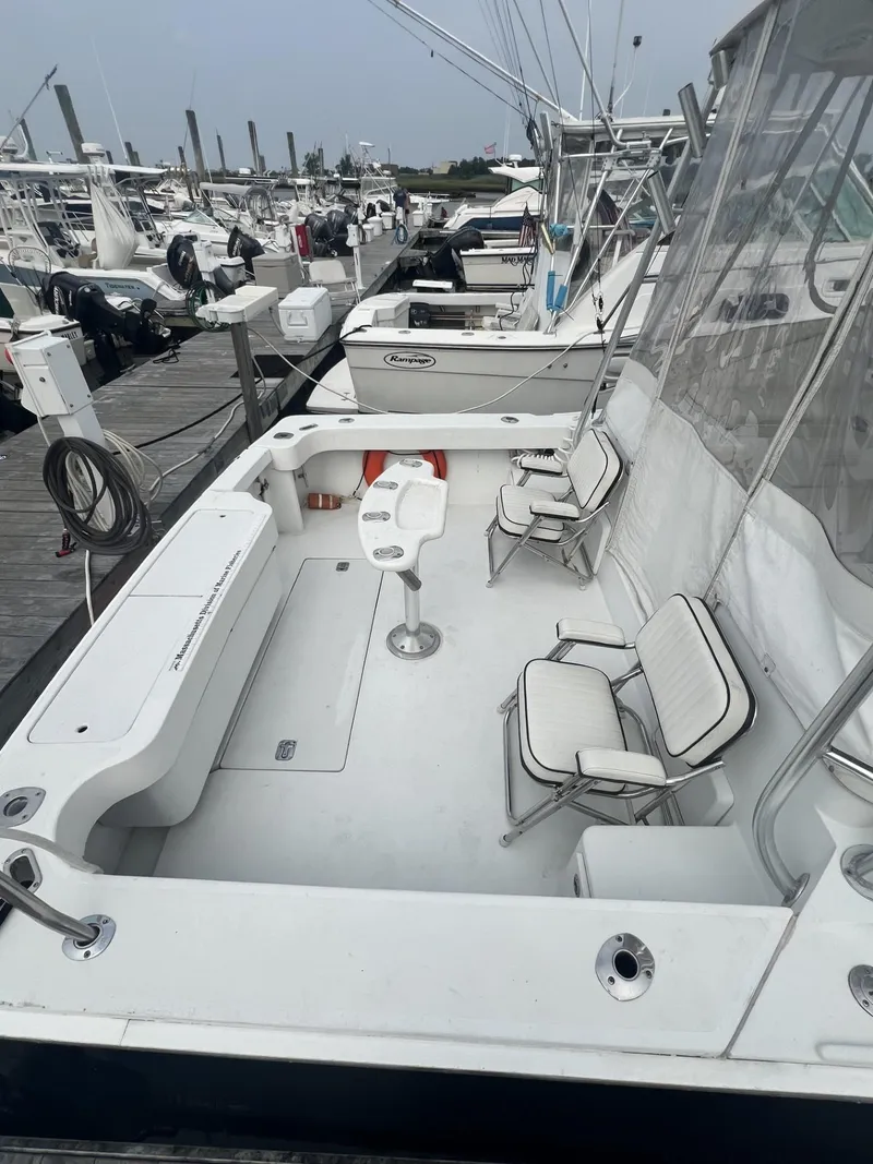 Slide: The Image of 1995 Luhrs 320 Open boat with spacious deck and seating at marina. - 4