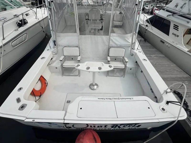Slide: The Image of 1995 Luhrs 320 Open boat with spacious deck and seating, docked at marina. - 5