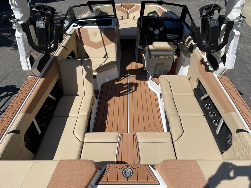 Slide: The Image of 2025 Nautique Super Air Nautique GS22 interior with tan seating and sleek design. - 5