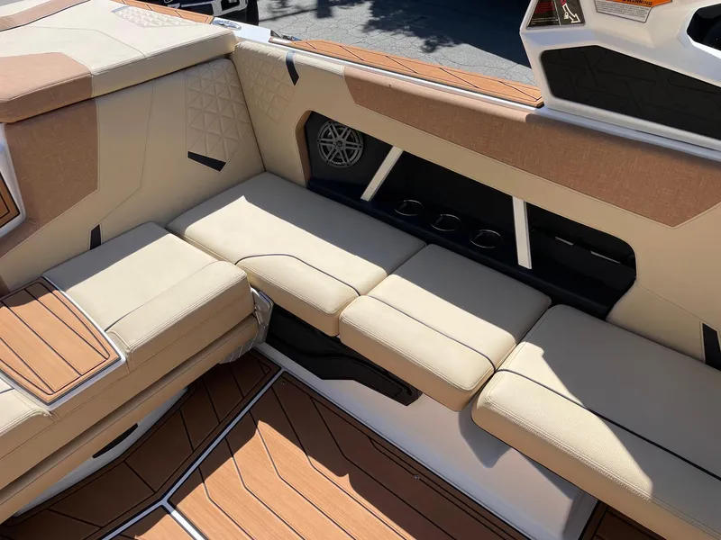Slide: The Image of 2025 Nautique Super Air Nautique GS22 interior with beige seating and modern design. - 9