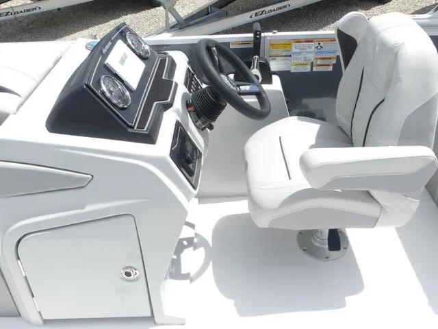 Slide: The Image of 2025 Hurricane FunDeck 2360 RE OB boat cockpit with steering wheel and captain's chair. - 13